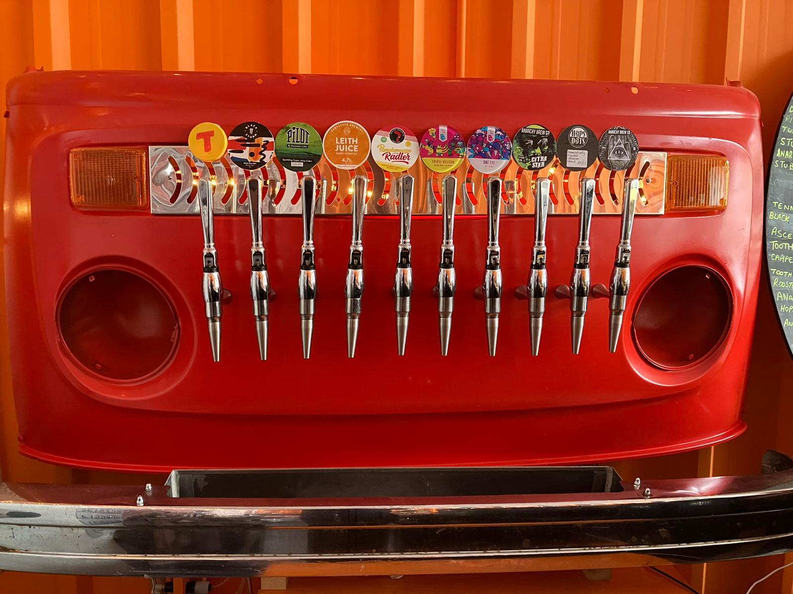 Creative tap wall built into the front of a red vehicle