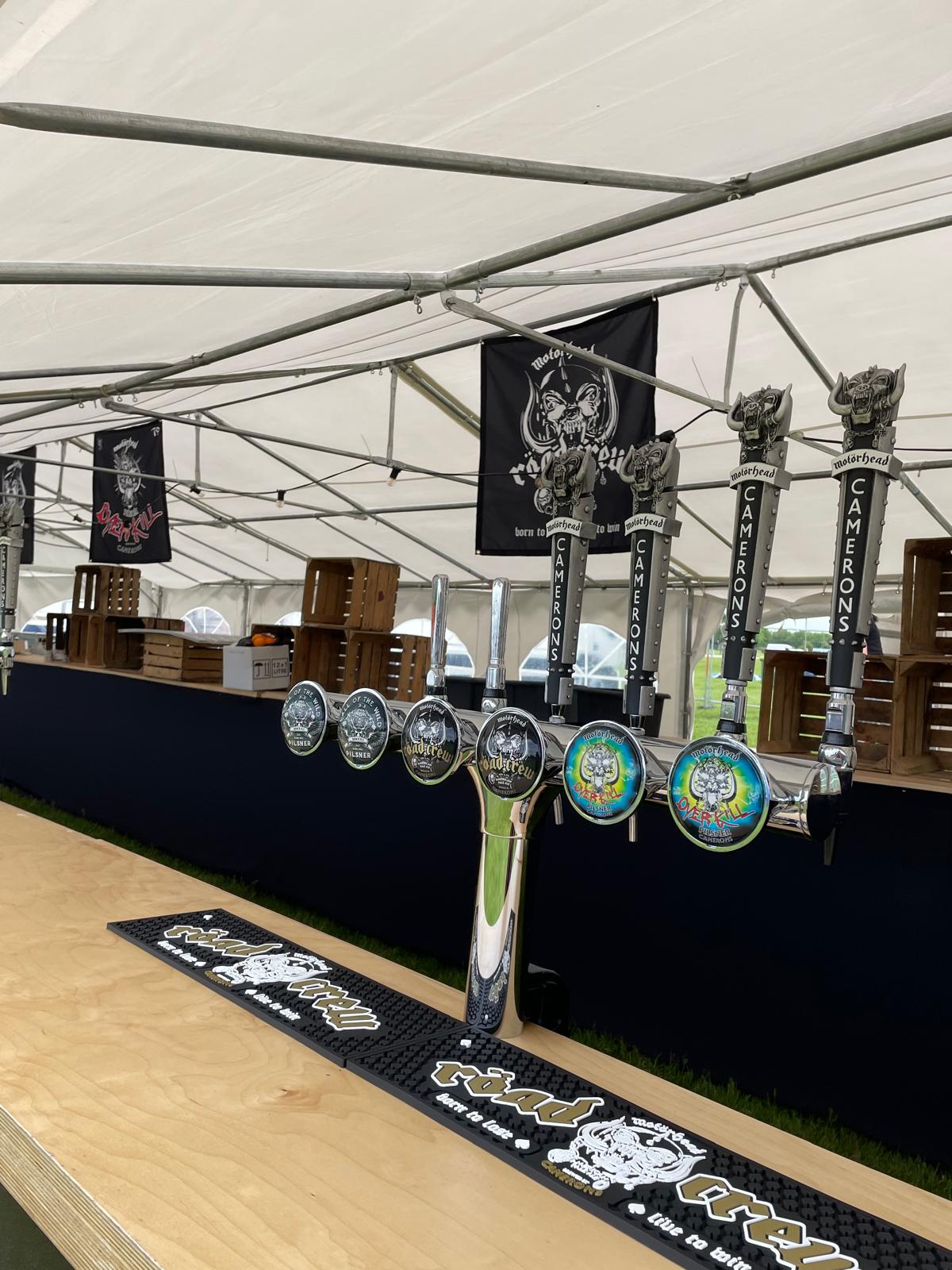 Close-up of festival beer taps with branding
