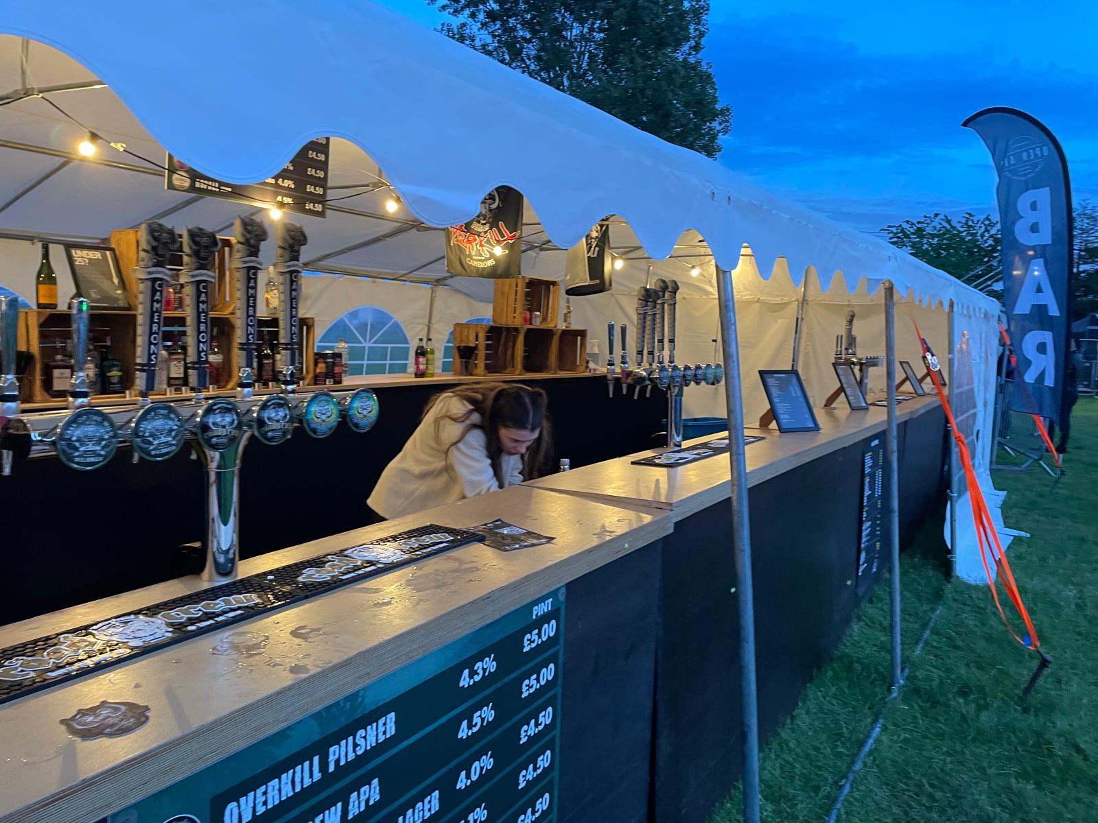 Long festival bar installed in a marquee